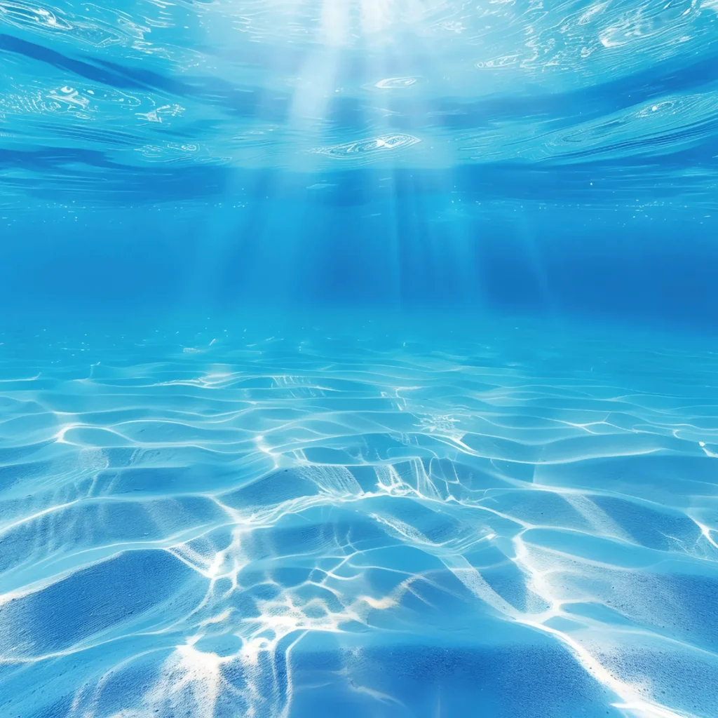 Sunlight rays shimmering through clear blue water